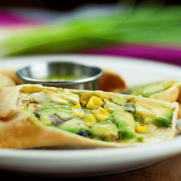 El Vaquero's quesadilla with avocado, corn, and black beans, served with green salsa.