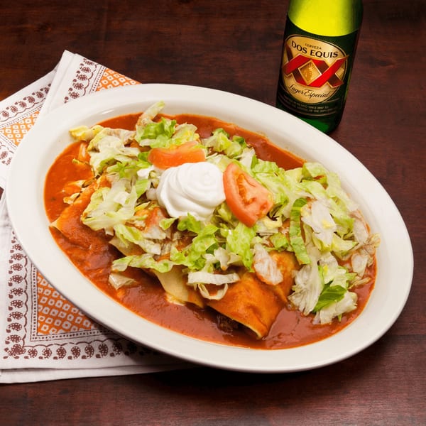 El Vaquero's enchiladas with red sauce, lettuce, tomatoes, sour cream, and a Dos Equis beer.